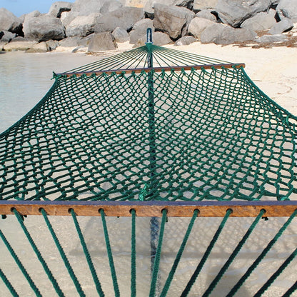 Green Jumbo Rope Hammock on a black Tri-Beam hammock stand at the water's edge.