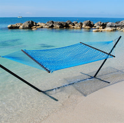 Light Blue Jumbo Rope Hammock on a black Tri-Beam hammock stand at the water's edge.