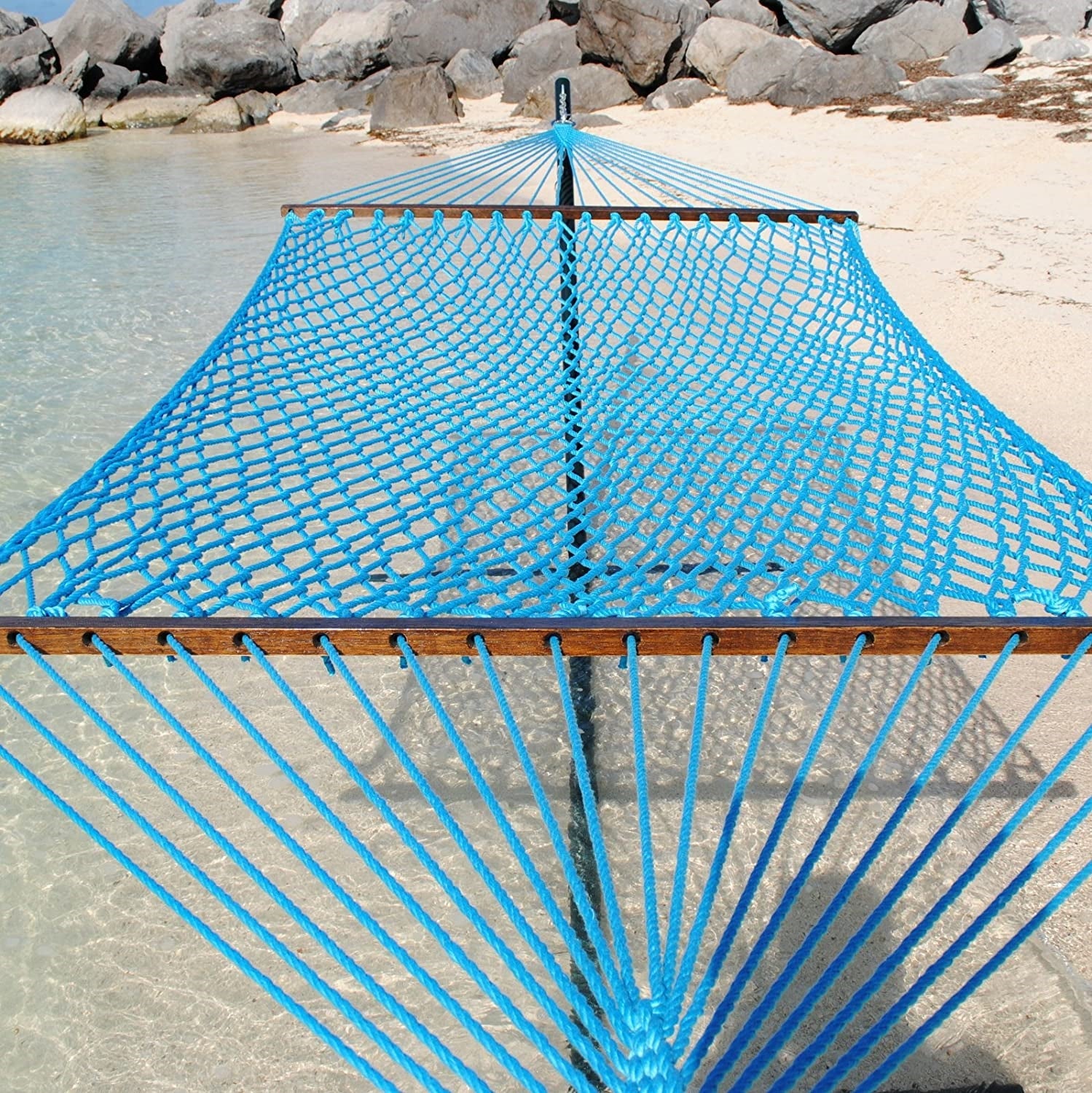Light Blue Jumbo Rope Hammock on a black Tri-Beam hammock stand at the water's edge.