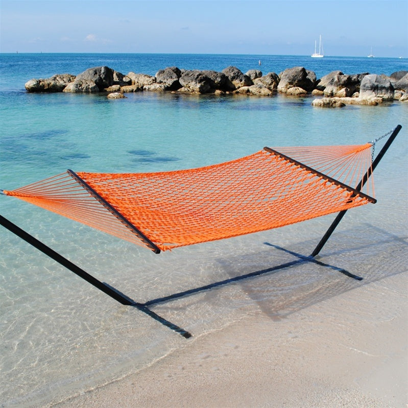 Orange Jumbo Rope Hammock on a black Tri-Beam hammock stand at the water's edge.