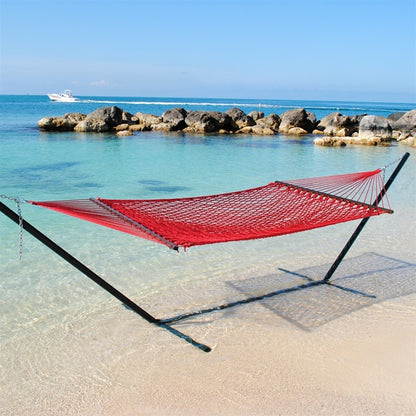Red Jumbo Rope Hammock on a black Tri-Beam hammock stand at the water's edge.