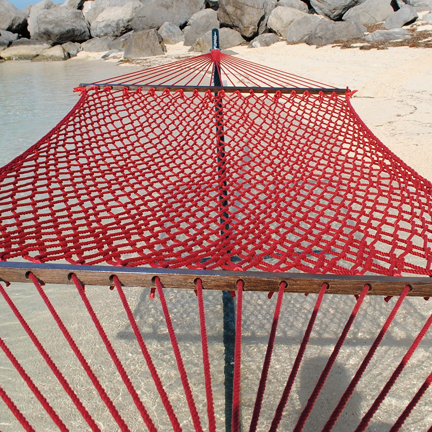 Red Jumbo Rope Hammock on a black Tri-Beam hammock stand at the water's edge.