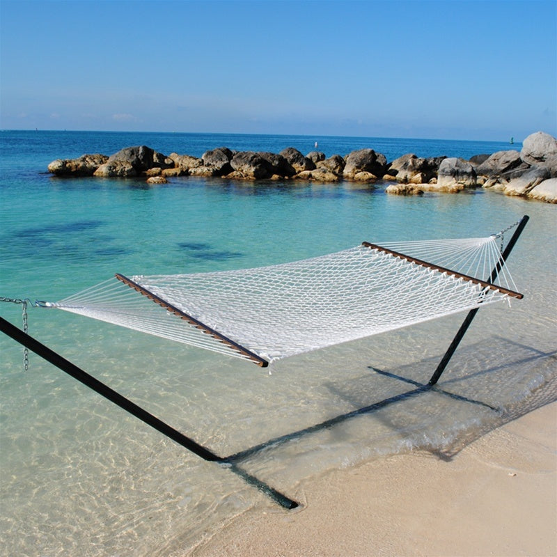White Jumbo Rope Hammock on a black Tri-Beam hammock stand at the water's edge.