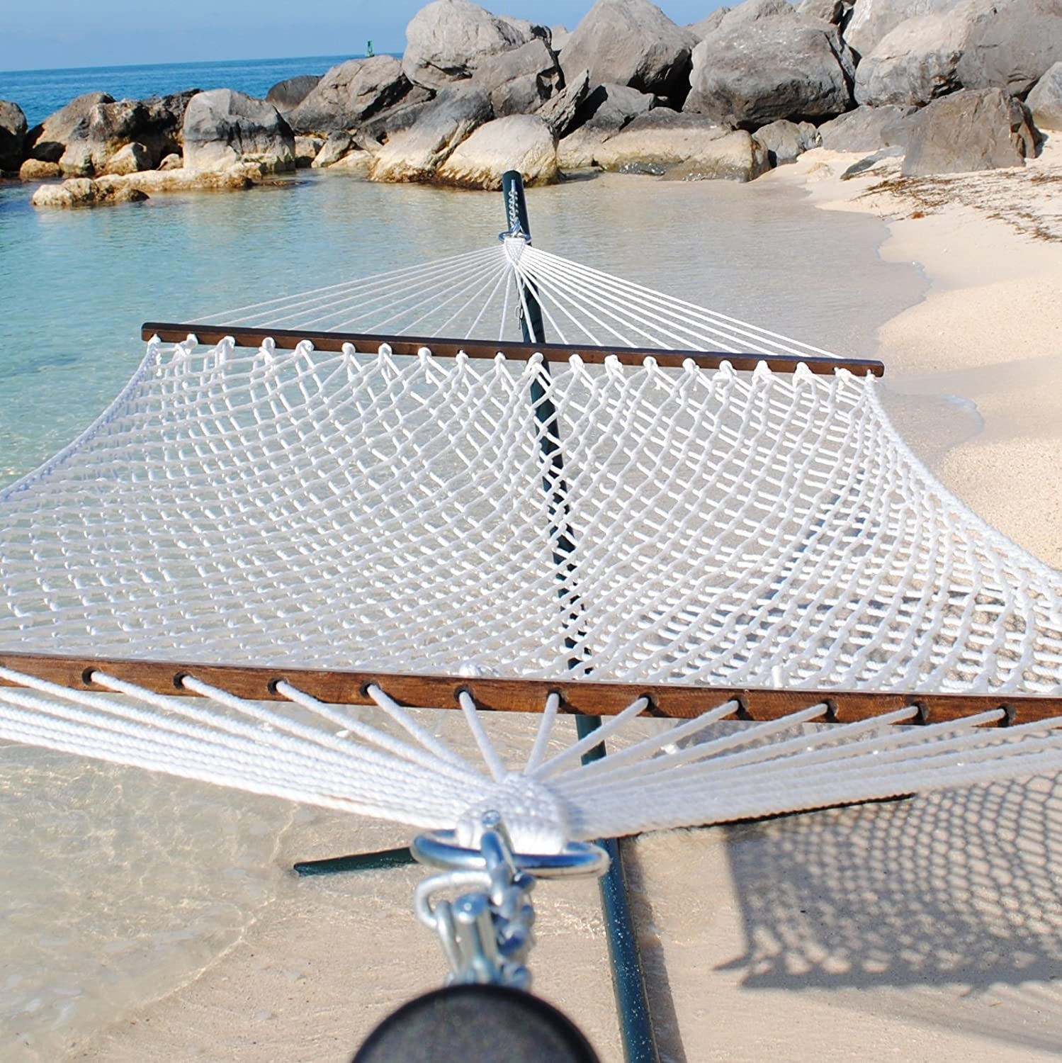 White Jumbo Rope Hammock on a black Tri-Beam hammock stand at the water's edge.
