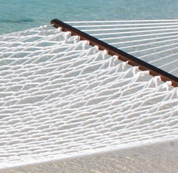 White Jumbo Rope Hammock on a black Tri-Beam hammock stand at the water's edge.