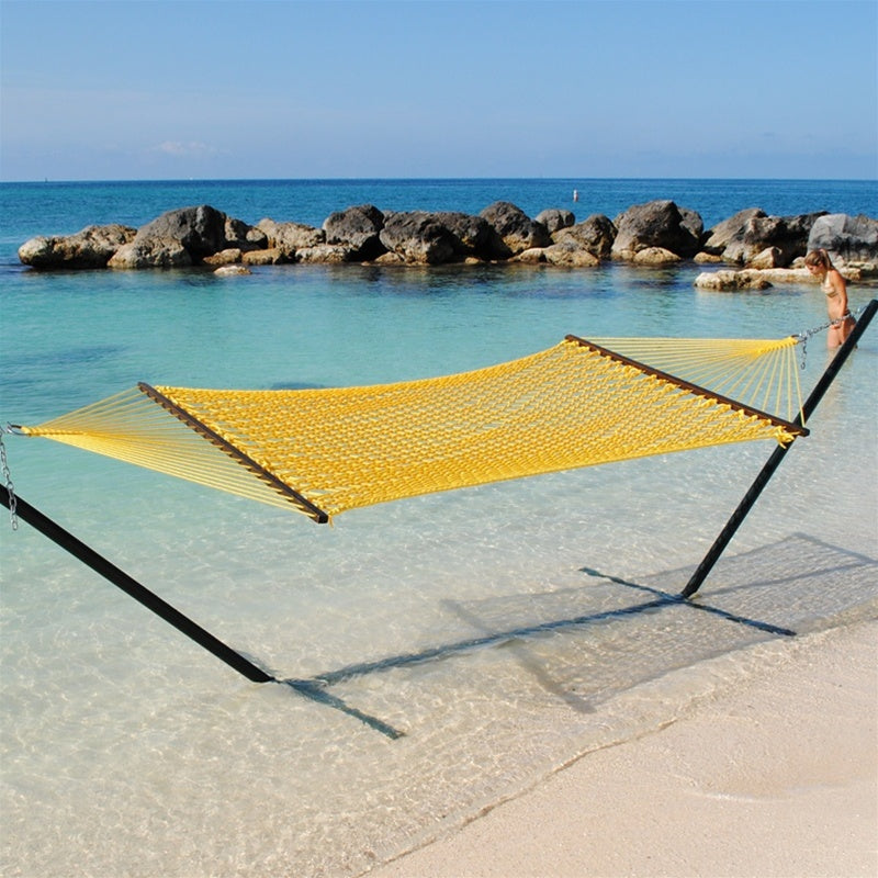 Yellow Jumbo Rope Hammock on a black Tri-Beam hammock stand at the water's edge.