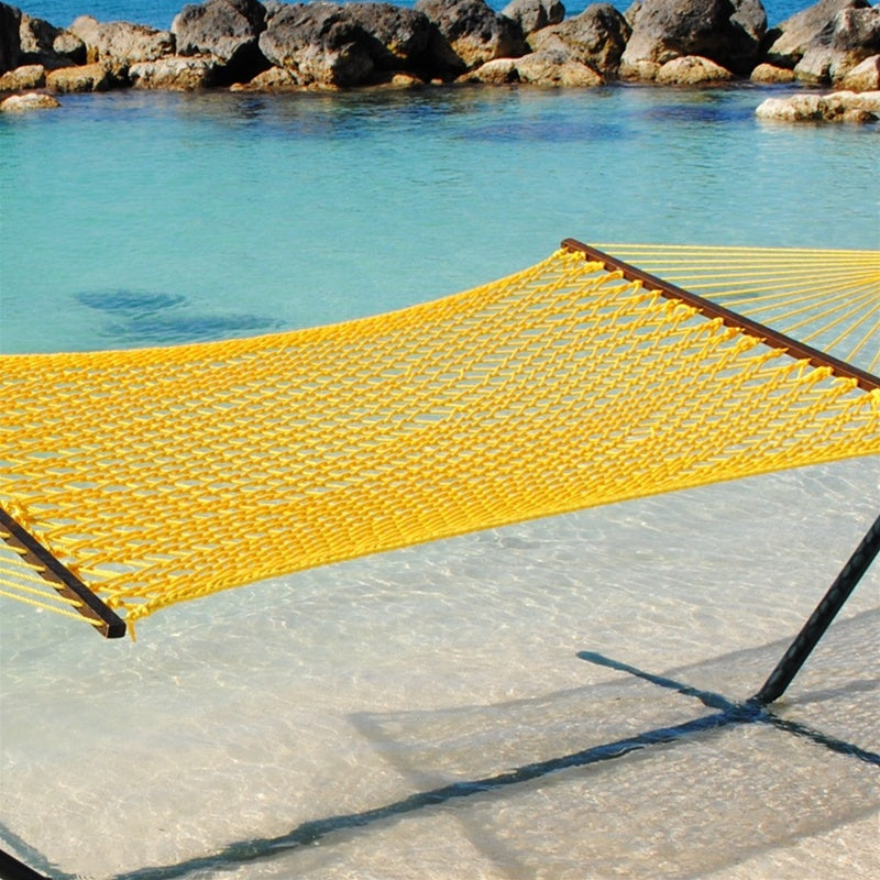 Yellow Jumbo Rope Hammock on a black Tri-Beam hammock stand at the water's edge.