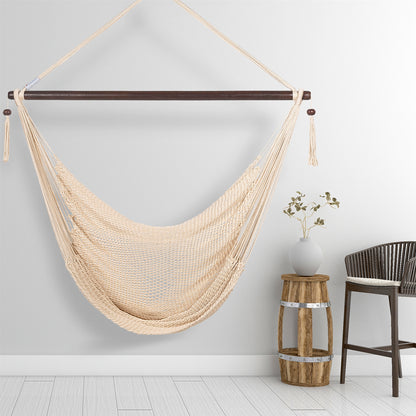 Cream Large Caribbean Hammock Chair hanging beside a barrel side table and rattan stool against a pale grey wall
