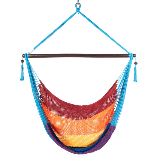 Front view of a rainbow Large Caribbean Hammock Chair showing the deep woven seat, built-in footrest and light blue end cords, on a white background