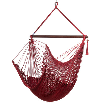 Large Caribbean Hammock Chair in red, hand-woven polyester cord with a dark hardwood spreader bar and tasseled ends, on a white background